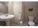 This half bath offers pedestal sink and space-saving toilet, perfect for guests at 3247 Moonlight Ct, Columbus, IN 47203