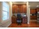 This well-lit home office features custom built-in cabinetry and a spacious granite desktop at 3247 Moonlight Ct, Columbus, IN 47203