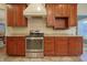 Kitchen featuring modern appliances and a white range hood at 3247 Moonlight Ct, Columbus, IN 47203