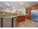Spacious kitchen featuring stainless steel appliances, granite counters, and tiled flooring at 3247 Moonlight Ct, Columbus, IN 47203