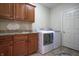 The laundry room has matching cabinetry and granite counters, with a sink for convenience at 3247 Moonlight Ct, Columbus, IN 47203
