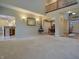 Open-concept living room with hardwood floors, a balcony, and an open view to the kitchen at 3247 Moonlight Ct, Columbus, IN 47203