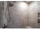 This tiled shower features a rain shower head and built-in niche shelves for bathroom essentials at 3247 Moonlight Ct, Columbus, IN 47203