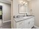 Modern bathroom with vanity, gray counter, stylish mirror, and soft lighting at 35 Osage Ct, Columbus, IN 47201