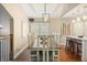 A view of the dining room and kitchen island featuring a long table with seating for eight at 35 Osage Ct, Columbus, IN 47201