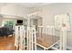 Dining area with a wood table, white chairs, modern chandelier, and views to the living area at 35 Osage Ct, Columbus, IN 47201