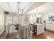 Open dining area with a wood table, white chairs and a view into the modern kitchen at 35 Osage Ct, Columbus, IN 47201