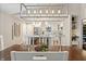 Bright dining room showing view into modern kitchen, featuring a contemporary chandelier and spacious layout at 35 Osage Ct, Columbus, IN 47201