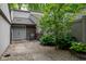 Front entryway with gray double doors, a rocking chair, and lush landscaping around the stone walkway at 35 Osage Ct, Columbus, IN 47201