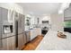 Bright kitchen boasts white cabinets, stainless steel appliances, granite countertop, and a view from the window at 35 Osage Ct, Columbus, IN 47201