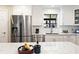 Modern kitchen featuring stainless steel appliances, white cabinets, granite countertop, and subway tile backsplash at 35 Osage Ct, Columbus, IN 47201