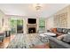 Open living room with a fireplace, hardwood floors, a stylish rug, and plenty of natural light at 35 Osage Ct, Columbus, IN 47201
