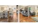 Open concept view of dining, kitchen, living areas with wood flooring and cohesive design elements at 35 Osage Ct, Columbus, IN 47201