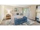 Sunlit main bedroom featuring a large bed, blue accent chair, and lots of natural light at 35 Osage Ct, Columbus, IN 47201