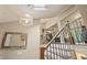 Modern staircase with wood railings and unique light fixture creating a welcoming transition between floors at 35 Osage Ct, Columbus, IN 47201