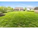 Home's backyard featuring a spacious lawn and patio area for outdoor activities and relaxation at 3630 Foxtail Dr, Indianapolis, IN 46235