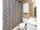 Cozy bathroom with a shower/tub combo, a white sink, a decorative shower curtain, and a mirrored cabinet at 3630 Foxtail Dr, Indianapolis, IN 46235