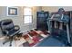 This bedroom has a treadmill, a chair, a window, and a dark cabinet at 3630 Foxtail Dr, Indianapolis, IN 46235