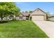 Charming single-story home with a well-manicured lawn and attached two-car garage at 3630 Foxtail Dr, Indianapolis, IN 46235