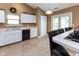 Practical kitchen with white cabinetry, durable countertops, and convenient access to the backyard at 3630 Foxtail Dr, Indianapolis, IN 46235
