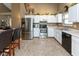 Well-lit kitchen with white cabinets, stainless steel appliances, and durable flooring at 3630 Foxtail Dr, Indianapolis, IN 46235