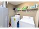 Bright laundry room with modern washer and dryer units and ample shelving for storage at 3630 Foxtail Dr, Indianapolis, IN 46235