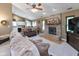 Open-concept living room featuring a fireplace, vaulted ceiling, and view of the kitchen at 3630 Foxtail Dr, Indianapolis, IN 46235
