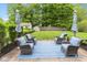 Patio featuring a paved area with blue outdoor rug, 4 cushioned chairs, and a grassy lawn at 3630 Foxtail Dr, Indianapolis, IN 46235