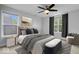 Primary bedroom featuring a queen bed, overhead fan, natural lighting and hardwood floors at 3658 Graceland Ave, Indianapolis, IN 46208