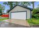 Detached garage with traditional siding and a white garage door; ample parking space and storage at 3658 Graceland Ave, Indianapolis, IN 46208
