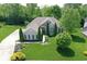 Stunning aerial view of brick home with pristine landscaping and mature trees providing shade and privacy at 3815 Harrison Crossing Ln, Greenwood, IN 46142