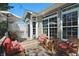 Back deck with outdoor furniture, including a glass table and cozy seating, for relaxing outdoors at 3815 Harrison Crossing Ln, Greenwood, IN 46142
