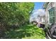 Landscaped backyard featuring well-maintained lawn and a hot tub, with deck and house visible at 3815 Harrison Crossing Ln, Greenwood, IN 46142