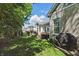 Beautifully landscaped backyard with a lush lawn, deck, hot tub, and views of surrounding homes at 3815 Harrison Crossing Ln, Greenwood, IN 46142