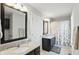 Bright bathroom featuring double vanities, granite countertops, framed mirrors, and a shower tub with curtain at 3815 Harrison Crossing Ln, Greenwood, IN 46142