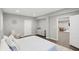 Spacious bedroom boasts hardwood floors, neutral paint, and a view into the living room area at 3815 Harrison Crossing Ln, Greenwood, IN 46142