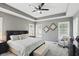 Spacious bedroom with tray ceilings, shutters, a ceiling fan, and a comfortable seating area at 3815 Harrison Crossing Ln, Greenwood, IN 46142