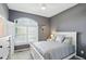 Cozy bedroom featuring a white bed frame, large windows with shutters, and neutral-toned decor at 3815 Harrison Crossing Ln, Greenwood, IN 46142