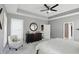 Bright bedroom with tray ceiling, shuttered windows, comfy chair and stylish decor at 3815 Harrison Crossing Ln, Greenwood, IN 46142