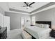 Bright Primary bedroom with tray ceiling, shuttered windows and open flow to bathroom at 3815 Harrison Crossing Ln, Greenwood, IN 46142