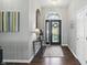 Elegant foyer with hardwood floors, a decorative chandelier, and an arched doorway with a glass-paned front door at 3815 Harrison Crossing Ln, Greenwood, IN 46142