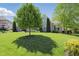 Spacious front yard featuring a beautiful tree that provides shade and privacy to this traditional style brick home at 3815 Harrison Crossing Ln, Greenwood, IN 46142