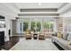 Inviting living room with large windows, a cozy fireplace, and hardwood flooring at 3815 Harrison Crossing Ln, Greenwood, IN 46142