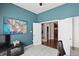 Home office with blue walls, closet and door storage and view to another room at 3815 Harrison Crossing Ln, Greenwood, IN 46142