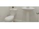 Contemporary bathroom with a toilet, pedestal sink, and neutral color palette at 3908 Andean Ct, Bargersville, IN 46106