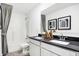 Contemporary bathroom showcasing dual sinks, black countertop, framed art and shower with gray accents at 3924 Andean Ct, Bargersville, IN 46106