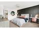 Modern bedroom featuring black accent wall, plush bedding, and dedicated workspace with white desk at 3924 Andean Ct, Bargersville, IN 46106