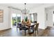 Dining room features modern light fixture, wood floors, sliding doors, and access to other rooms at 3924 Andean Ct, Bargersville, IN 46106