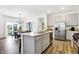 Modern kitchen featuring stainless steel appliances, a central island and an adjacent dining area at 3924 Andean Ct, Bargersville, IN 46106