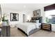 Well-lit main bedroom with decorative art, side tables, a large bed, and a view to the neighborhood at 3924 Andean Ct, Bargersville, IN 46106